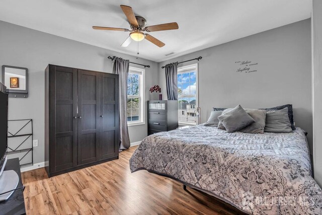 904 4th St, Union Beach, NJ 07735 - bedroom featuring a ceiling fan, visible vents, light wood-style flooring, and baseboards