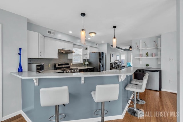 904 4th St, Union Beach, NJ 07735 - kitchen with light countertops, stainless steel appliances, visible vents, and under cabinet range hood
