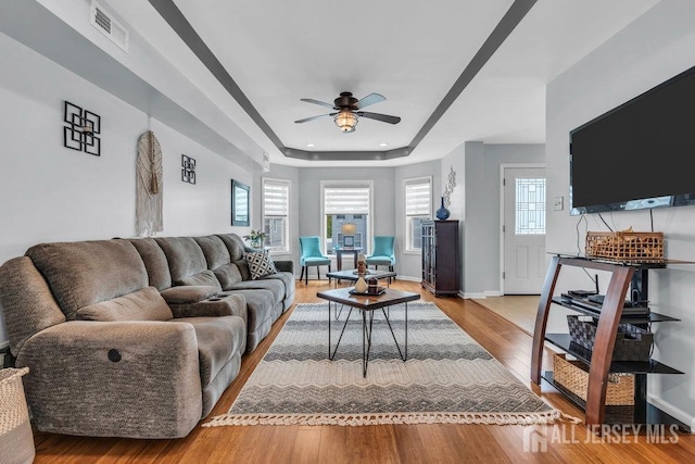 904 4th St, Union Beach, NJ 07735 - living area with light wood finished floors, plenty of natural light, visible vents, and a ceiling fan