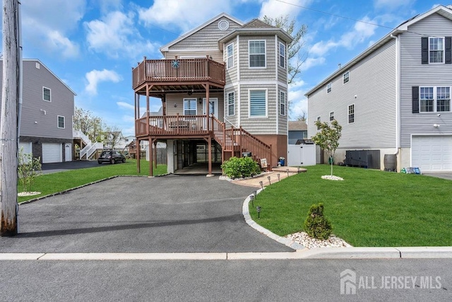 904 4th St, Union Beach, NJ 07735 - view of front facade with a front lawn, driveway, stairway, and an attached garage