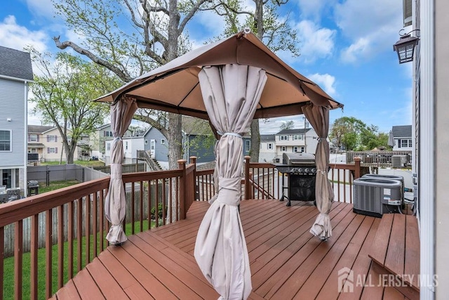 904 4th St, Union Beach, NJ 07735 - wooden terrace featuring fence, a grill, a residential view, central AC unit, and a gazebo