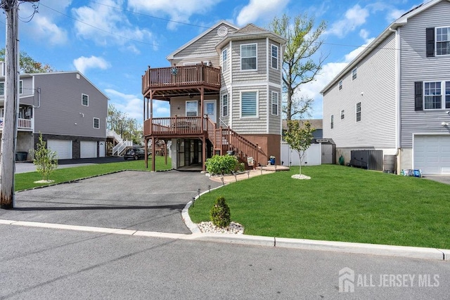 904 4th St, Union Beach, NJ 07735 - view of front of house featuring a garage, a front yard, aphalt driveway, and stairs