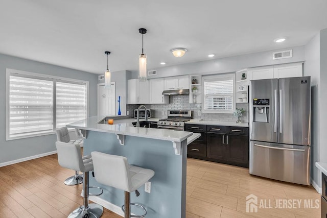 904 4th St, Union Beach, NJ 07735 - kitchen featuring a sink, stainless steel appliances, a kitchen breakfast bar, visible vents, and light countertops