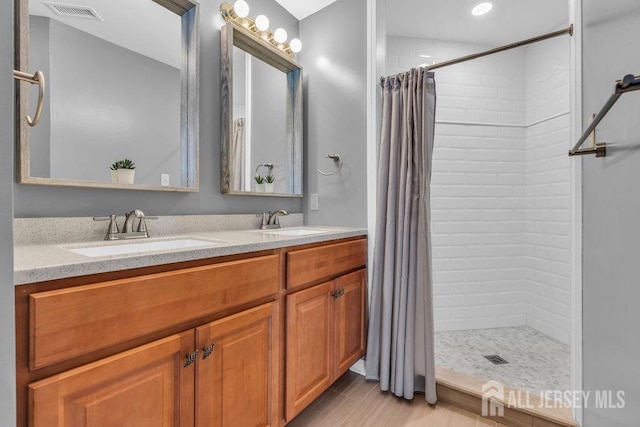 904 4th St, Union Beach, NJ 07735 - full bathroom featuring visible vents, a tile shower, and a sink