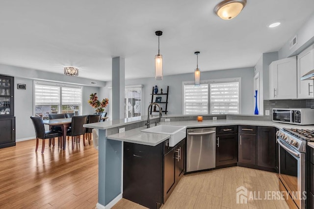 904 4th St, Union Beach, NJ 07735 - kitchen with light countertops, stainless steel appliances, visible vents, and a sink