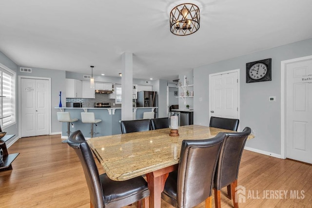 904 4th St, Union Beach, NJ 07735 - dining space featuring baseboards, light wood-style flooring, visible vents, and a chandelier