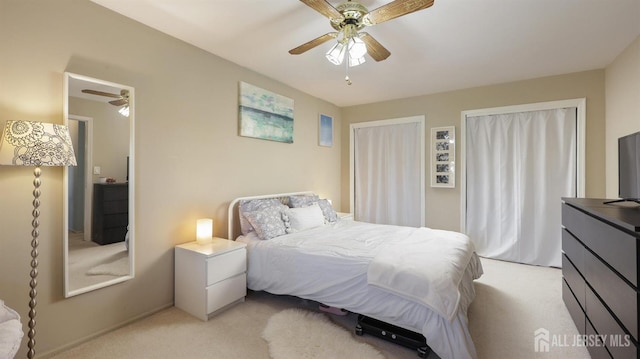 bedroom with light carpet and ceiling fan