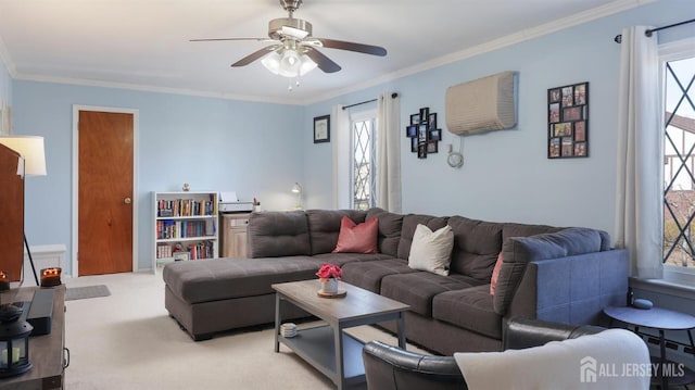 carpeted living room featuring crown molding, plenty of natural light, and ceiling fan