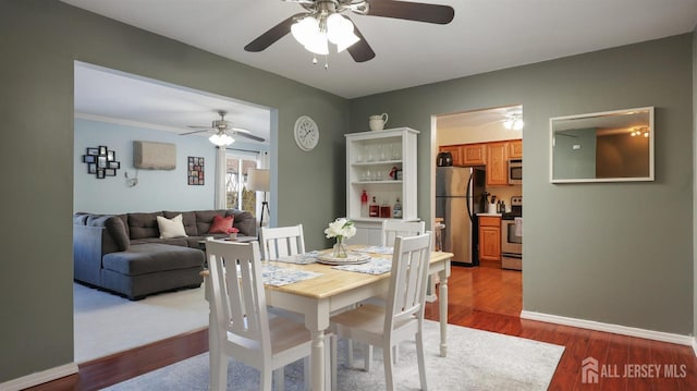 dining room with hardwood / wood-style floors and ceiling fan