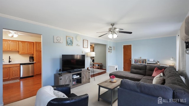 living area with ceiling fan, ornamental molding, and light wood finished floors