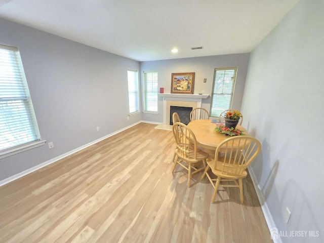3 Great Beds Way S, Amboy, NJ 08879 - dining space with light wood-style floors, plenty of natural light, a fireplace with raised hearth, baseboards, and recessed lighting