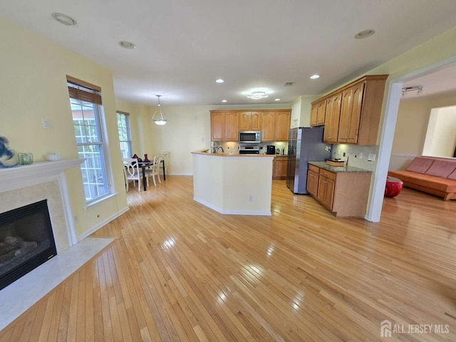 3 Great Beds Way S, Amboy, NJ 08879 - kitchen featuring stainless steel appliances, light wood-type flooring, a premium fireplace, recessed lighting, and baseboards
