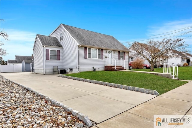 cape cod home featuring a shingled roof, fence, and a front yard