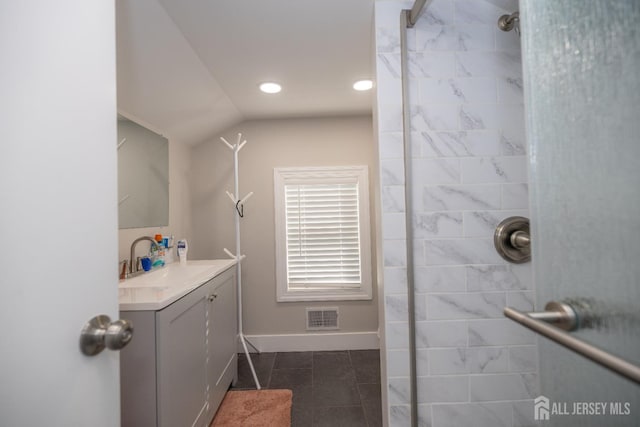 118 Holly St, Port Reading, NJ 07064 - full bath with a tile shower, tile patterned flooring, vanity, baseboards, and lofted ceiling