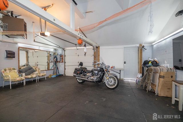 118 Holly St, Port Reading, NJ 07064 - garage with a garage door opener and concrete block wall