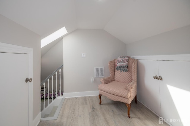 118 Holly St, Port Reading, NJ 07064 - living area with wood finished floors, vaulted ceiling, and a skylight