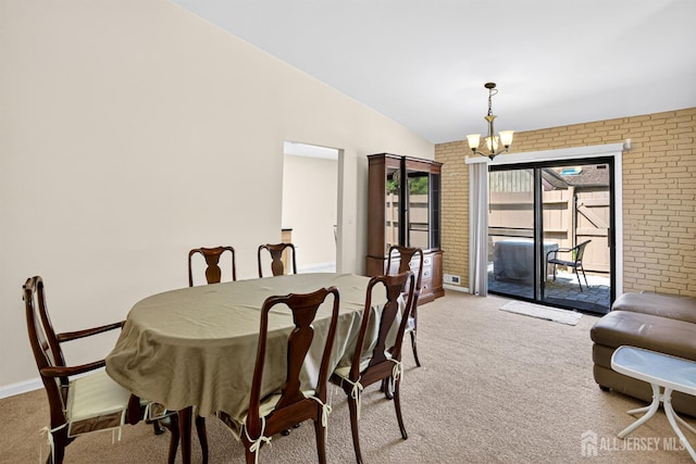 29 Whittney Ct, East Brunswick, NJ 08816 - dining room featuring a chandelier, light colored carpet, brick wall, and lofted ceiling
