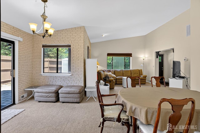 29 Whittney Ct, East Brunswick, NJ 08816 - carpeted dining area with brick wall, plenty of natural light, a chandelier, and vaulted ceiling