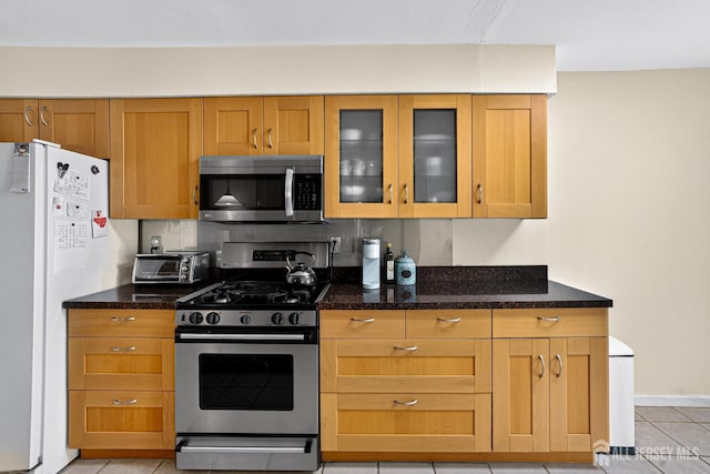 29 Whittney Ct, East Brunswick, NJ 08816 - kitchen with stainless steel appliances, glass insert cabinets, light tile patterned floors, and dark stone countertops