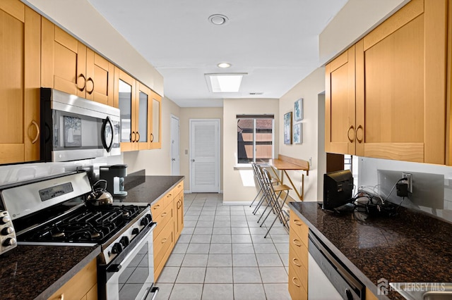 29 Whittney Ct, East Brunswick, NJ 08816 - kitchen with stainless steel appliances, glass insert cabinets, light tile patterned floors, and light brown cabinetry