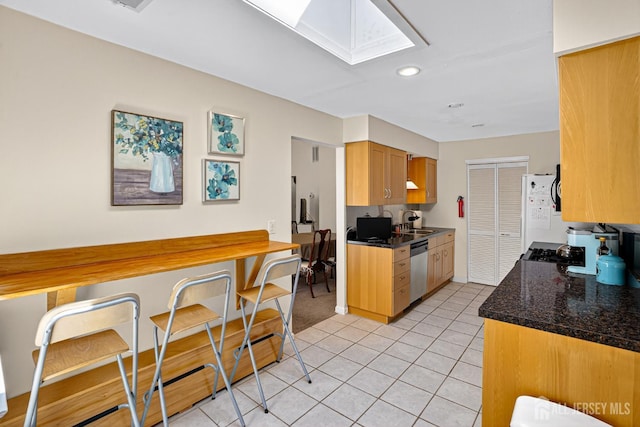 29 Whittney Ct, East Brunswick, NJ 08816 - kitchen featuring dishwasher, a skylight, light tile patterned flooring, freestanding refrigerator, and recessed lighting