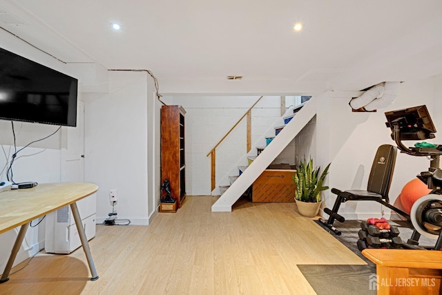 workout area with wood finished floors and recessed lighting