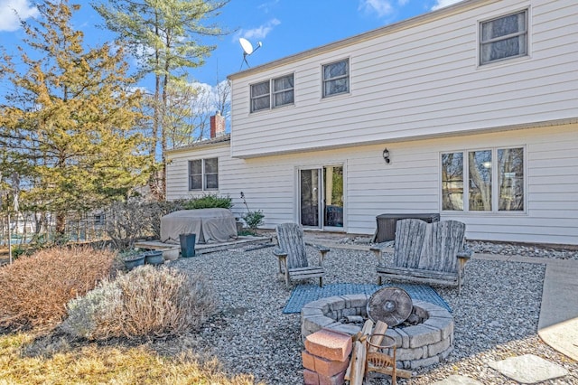 back of property featuring a fire pit