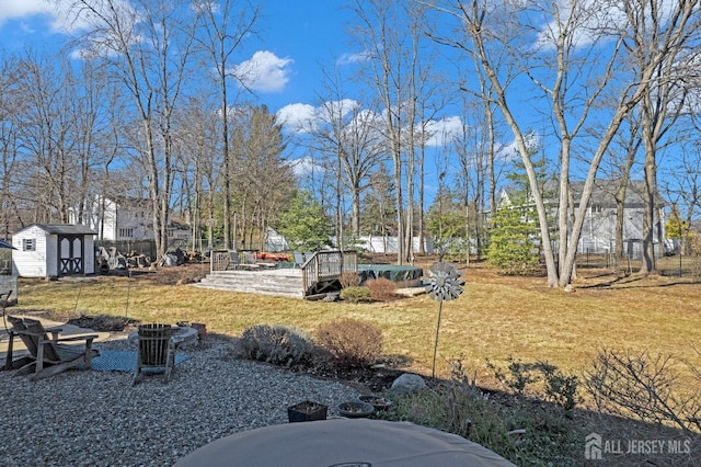 view of yard with a storage shed and an outdoor structure