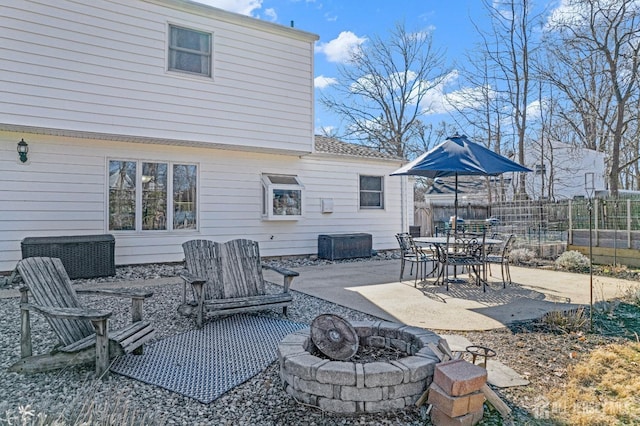 view of patio / terrace featuring fence and a fire pit