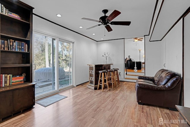 office space featuring a dry bar, a ceiling fan, wood finished floors, crown molding, and recessed lighting