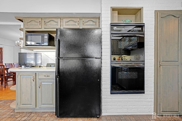 kitchen with black appliances, backsplash, and light countertops