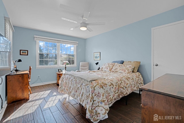 bedroom with baseboards, dark wood finished floors, and a ceiling fan