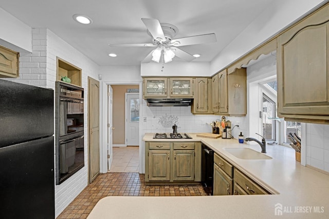 kitchen with black appliances, a sink, light countertops, and under cabinet range hood