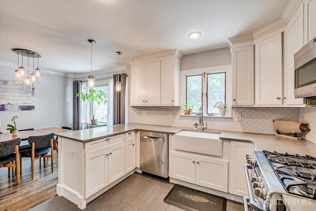24 Turner Ct, Metuchen, NJ 08840 - kitchen with stainless steel appliances, a peninsula, white cabinets, decorative backsplash, and decorative light fixtures