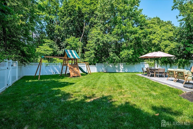 24 Turner Ct, Metuchen, NJ 08840 - fenced backyard featuring a playground and a patio area