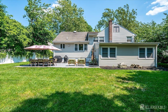 24 Turner Ct, Metuchen, NJ 08840 - back of property with a chimney, a patio area, and a lawn