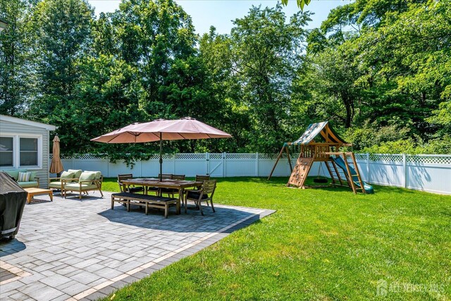 24 Turner Ct, Metuchen, NJ 08840 - fenced backyard with a patio area, outdoor lounge area, a playground, and outdoor dining space