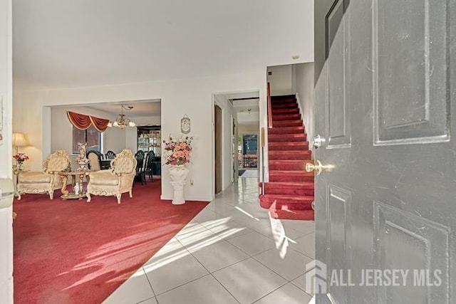 39 Gary Ct, South Brunswick, NJ 08810 - tiled foyer featuring stairway, a chandelier, and carpet floors