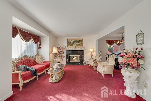 39 Gary Ct, South Brunswick, NJ 08810 - living room with carpet floors, a chandelier, and a glass covered fireplace