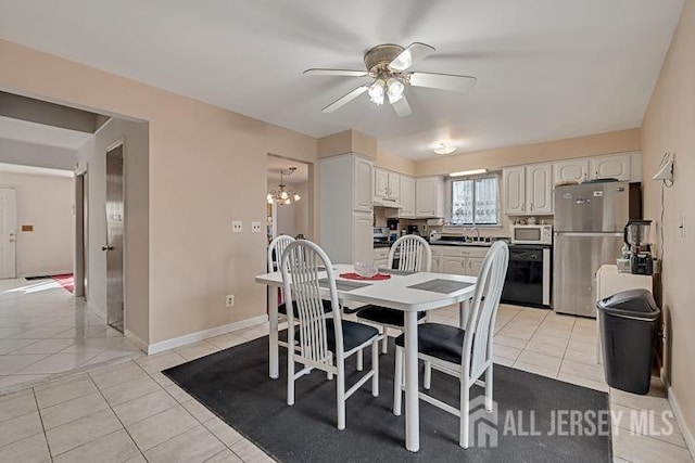 39 Gary Ct, South Brunswick, NJ 08810 - dining area featuring ceiling fan, light tile patterned floors, a chandelier, and baseboards