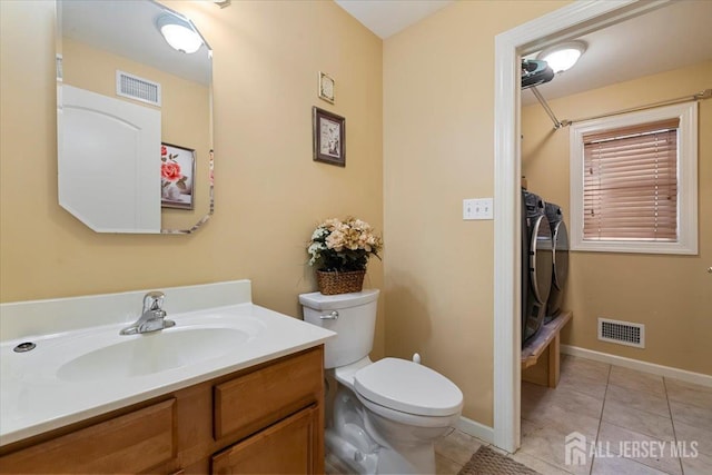 861 S Birch St S, Perth Amboy, NJ 08861 - bathroom featuring washer and clothes dryer, toilet, vanity, tile patterned floors, and baseboards