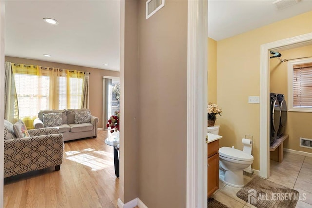 861 S Birch St S, Perth Amboy, NJ 08861 - living room with independent washer and dryer, light wood-type flooring, baseboards, and recessed lighting
