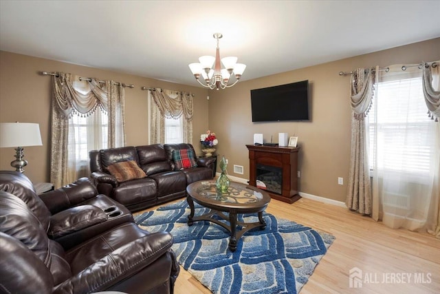 861 S Birch St S, Perth Amboy, NJ 08861 - living area with a chandelier, light wood-style floors, a fireplace, and baseboards