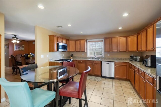 861 S Birch St S, Perth Amboy, NJ 08861 - kitchen with appliances with stainless steel finishes, recessed lighting, a sink, ceiling fan, and brown cabinets