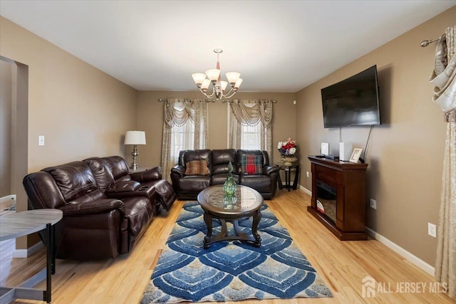 861 S Birch St S, Perth Amboy, NJ 08861 - living room featuring a chandelier, light wood-style flooring, and baseboards