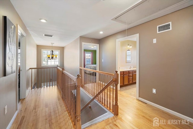 861 S Birch St S, Perth Amboy, NJ 08861 - hallway featuring attic access, an upstairs landing, light wood-type flooring, baseboards, and recessed lighting