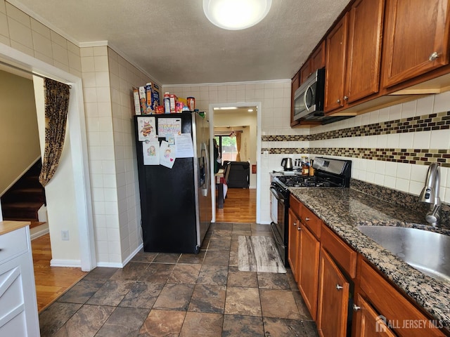 74 Probasco Rd, East Windsor, NJ 08520 - kitchen featuring stainless steel appliances, brown cabinets, tasteful backsplash, a textured ceiling, and ornamental molding
