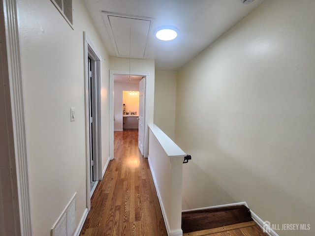 74 Probasco Rd, East Windsor, NJ 08520 - corridor featuring attic access, wood finished floors, and an upstairs landing