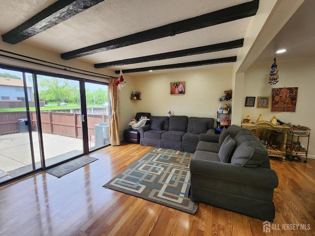 74 Probasco Rd, East Windsor, NJ 08520 - living area with wood finished floors, beamed ceiling, and a textured ceiling