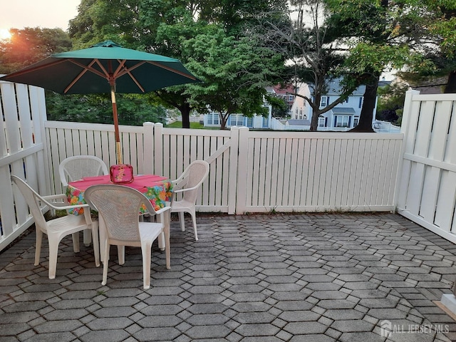 view of patio with fence and outdoor dining space